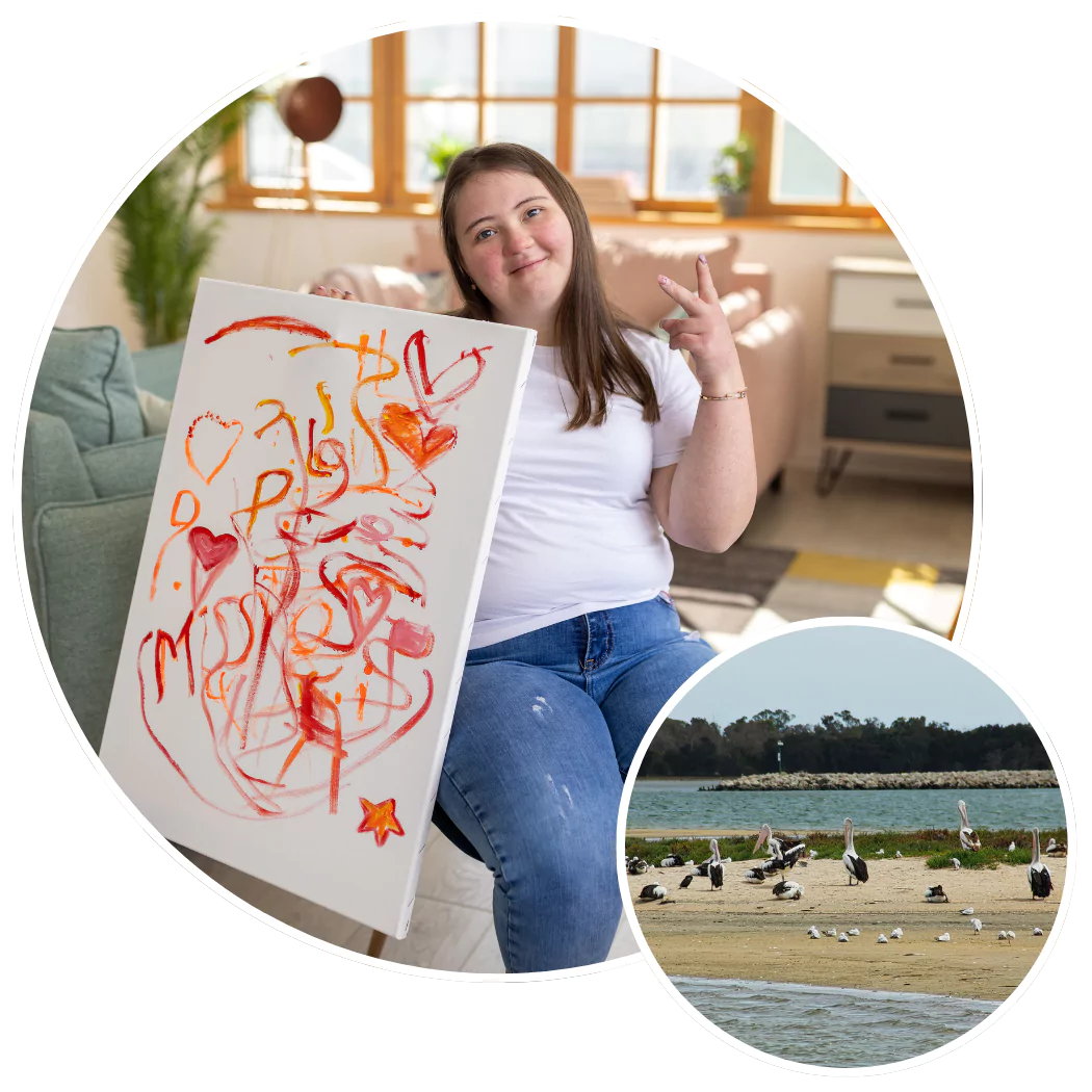 Happy disabled woman with down syndrome holding artwork up to the camera